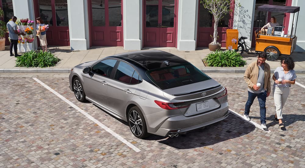 High angle view of a grey 2025 Toyota Camry parked outside a building.