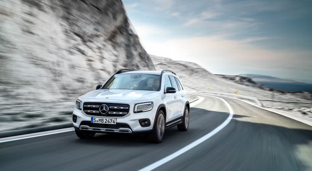 A white 2020 Mercedes-Benz GLB, a used Mercedes-Benz for sale near Ashland, driving around a bend.