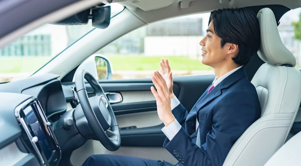 A person is shown hands-free driving.