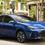 A blue 2019 Toyota Corolla for sale is shown parked on a city street.