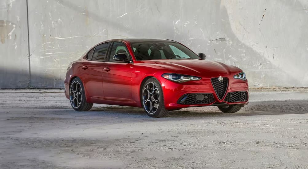 A red 2024 Alfa Romeo Giulia is shown parked on a sunny day.