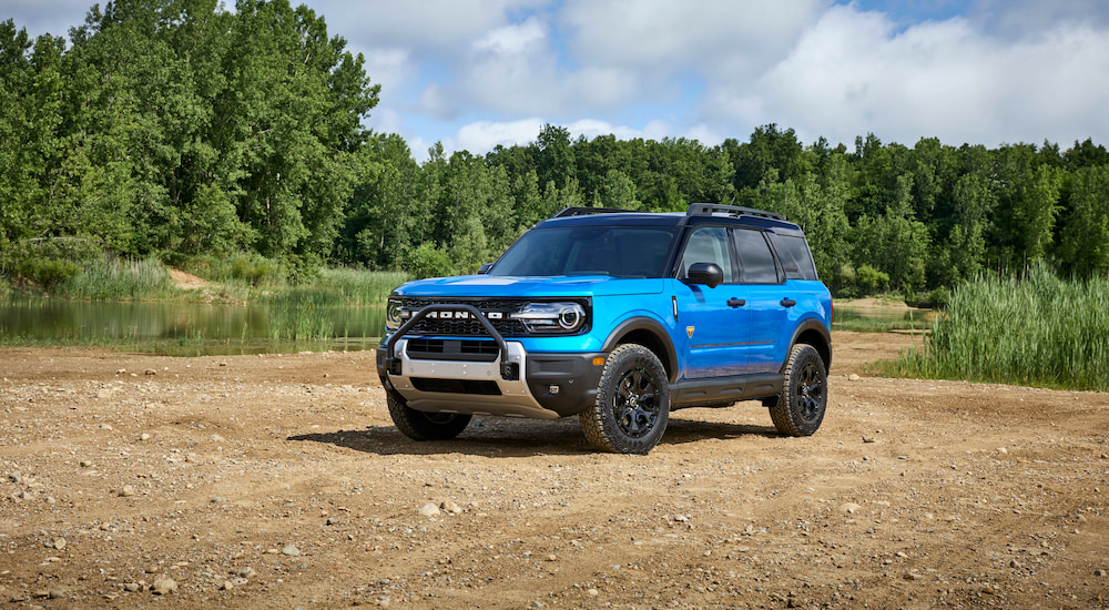 A blue 2025 Ford Bronco Sport Badlands Sasquatch parked near a small pond.