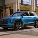 A blue 2025 Chevy Trailblazer RS driving in a city.