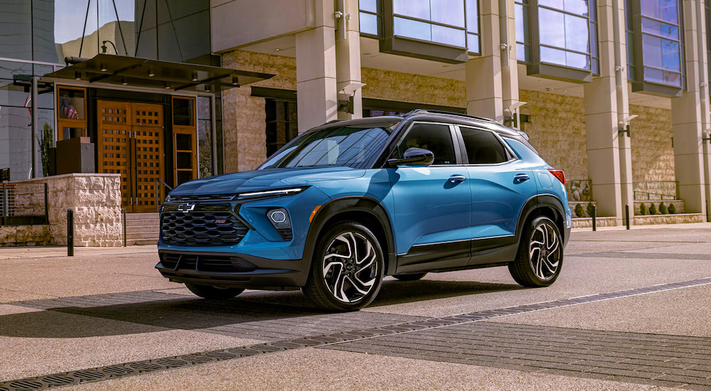 A blue 2025 Chevy Trailblazer RS driving in a city.