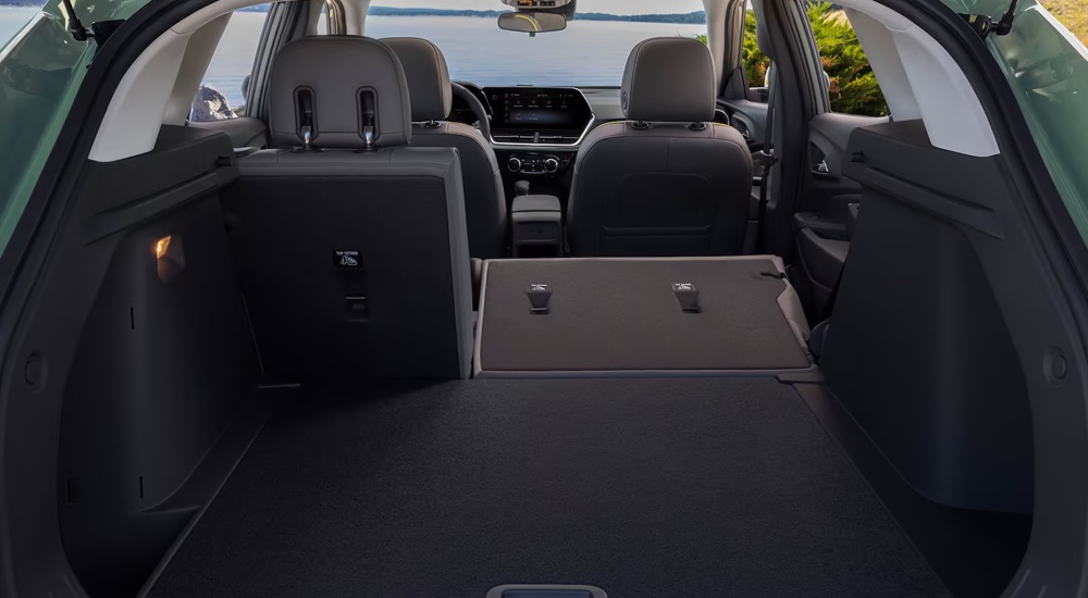 The rear cargo area and fold-down seating in a 2025 Chevy Trax ACTIV.