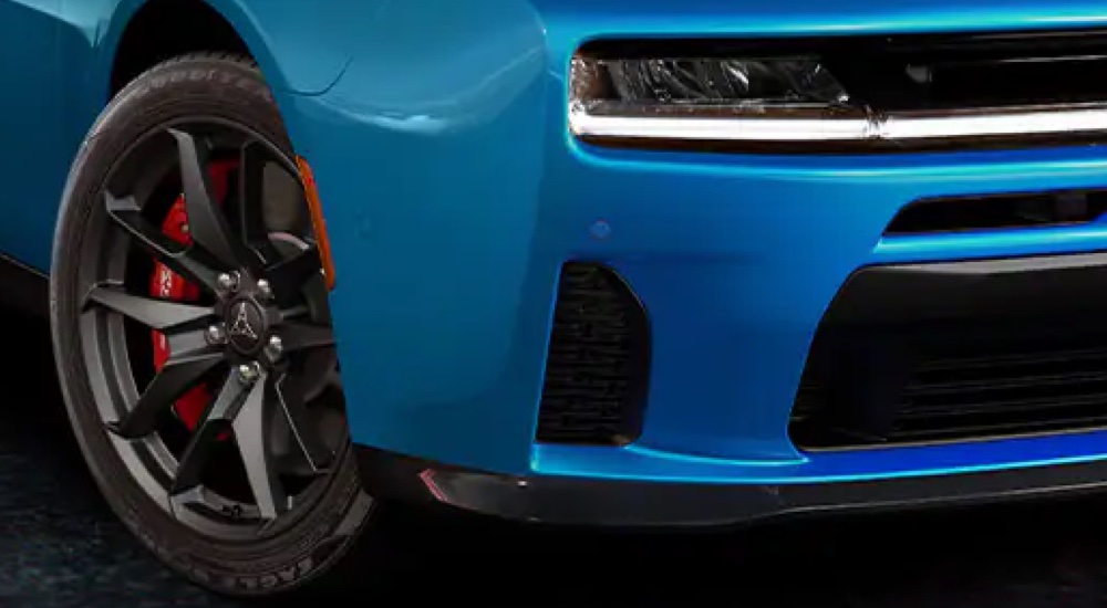 Close-up of the front wheel and grill of a blue 2025 Dodge Charger Sixpack at a Dodge dealer.