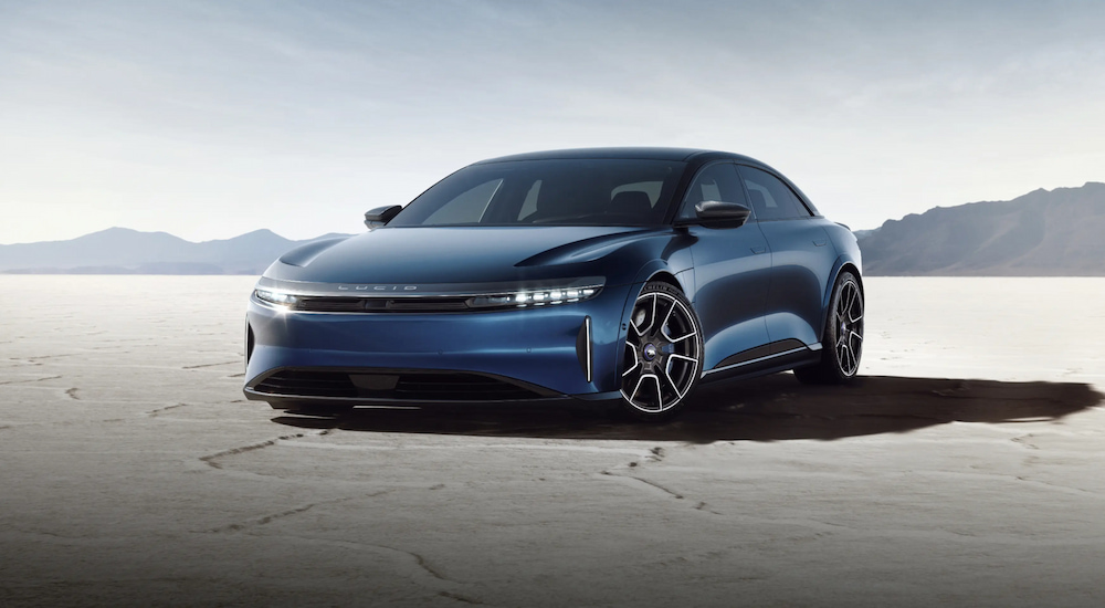 A blue 2024 Lucid Air Sapphire parked on salt flats.