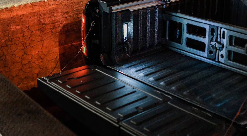 Close-up of the open tailgate on a black 2024 Ram 1500.