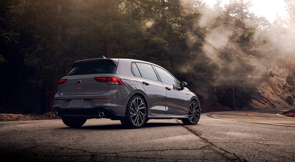 A grey 2022 Volkswagen Golf GTI is shown from the rear at an angle.