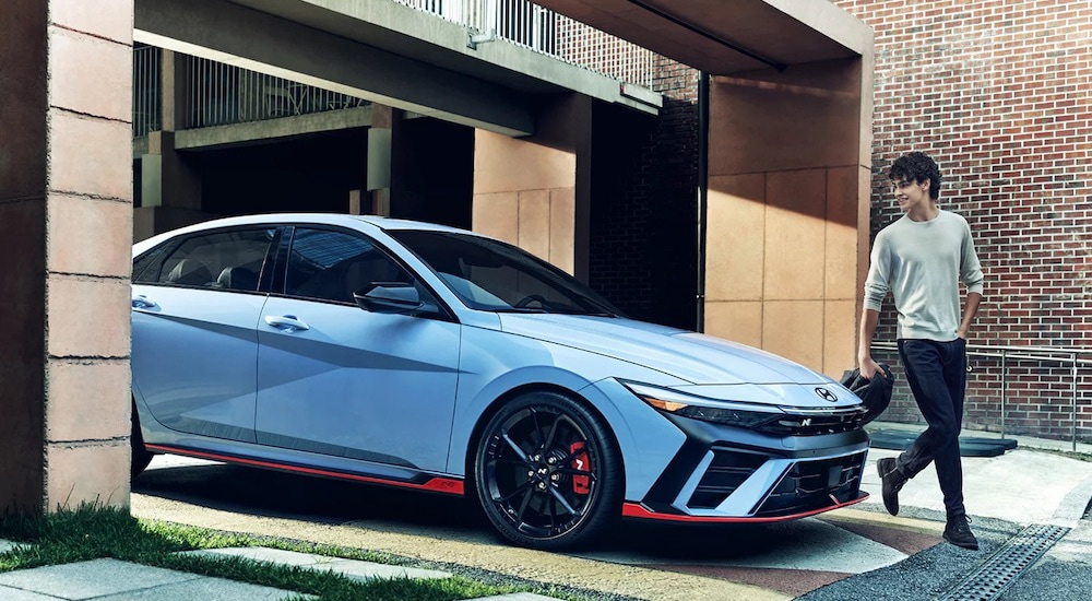 A blue 2024 Hyundai Elantra N is shown from the side.