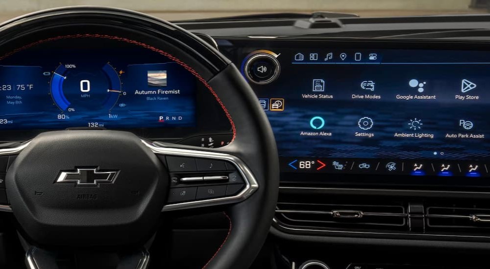 A close-up of the steering wheel and digital displays are shown in a 2025 Chevy Equinox for sale.