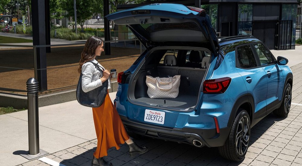 A blue 2025 Chevy Trailblazer RS is shown with its tailgate door open.