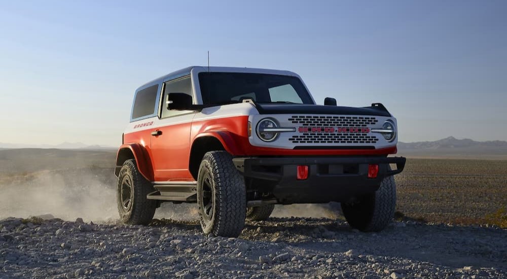 A red white and blue 2025 Ford Bronco Stroppe Special Edition Package is shown driving off-road.