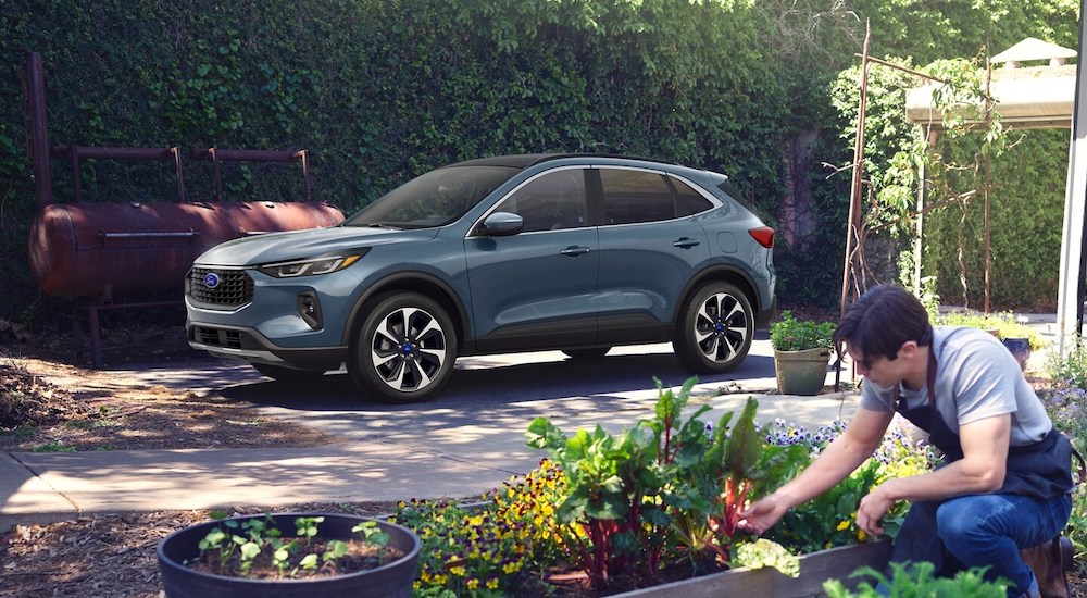 A grey 2025 Ford Escape ST-Line parked on a driveway.