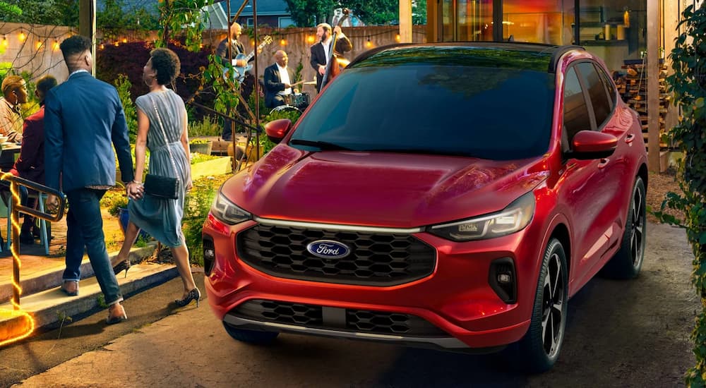 A red 2025 Ford Escape ST-Line parked at a party.