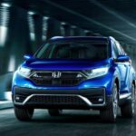 A blue 2020 Honda CR-V Touring driving in a tunnel.