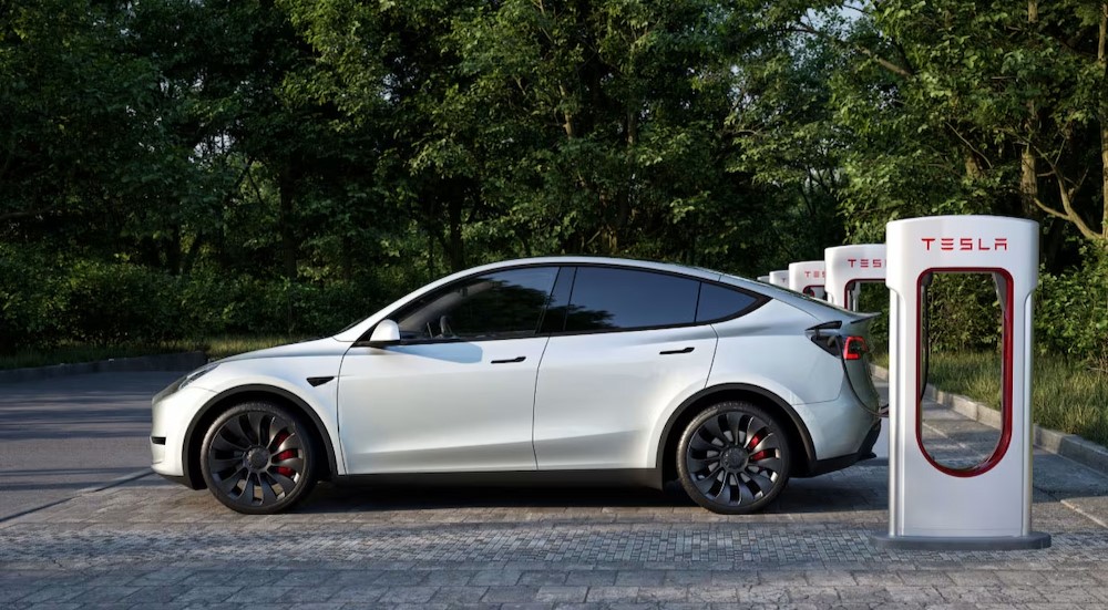 A white 2024 Tesla Model Y is shown charging.