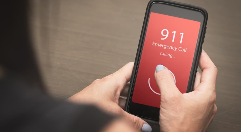 A person is shown calling 911.