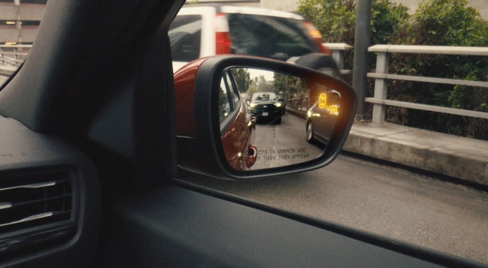 Close-up of the blind spot alert on the side mirror of a 2025 Ford Escape.