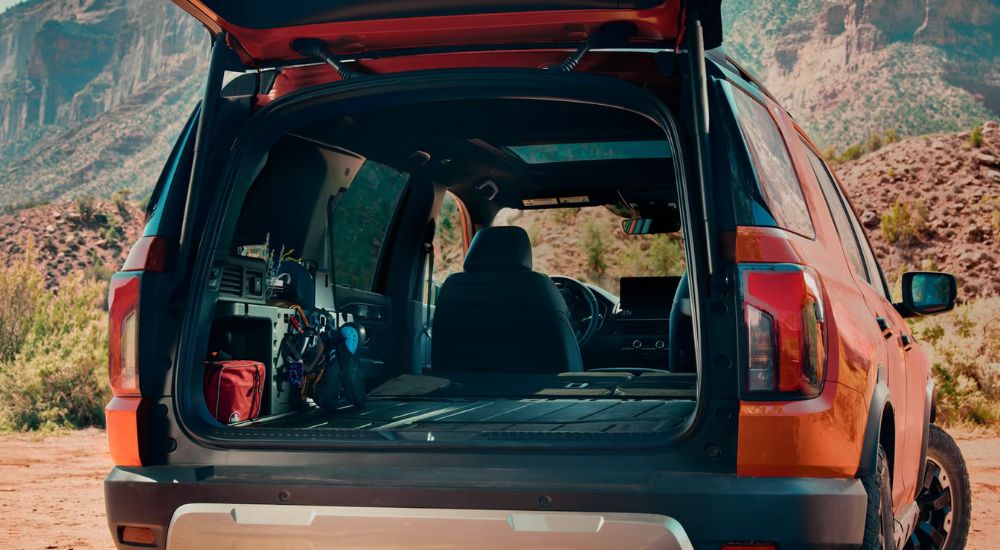 The rear cargo area of an orange 2026 Honda Passport TrailSport Elite.