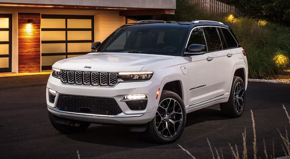 A white 2025 Jeep Grand Cherokee L parked on a driveway.