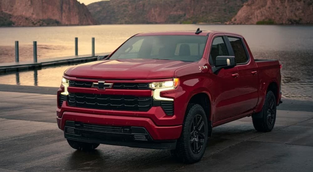 A red 2024 Chevy Silverado 1500 RST is shown parked after visiting a Chevy dealer.