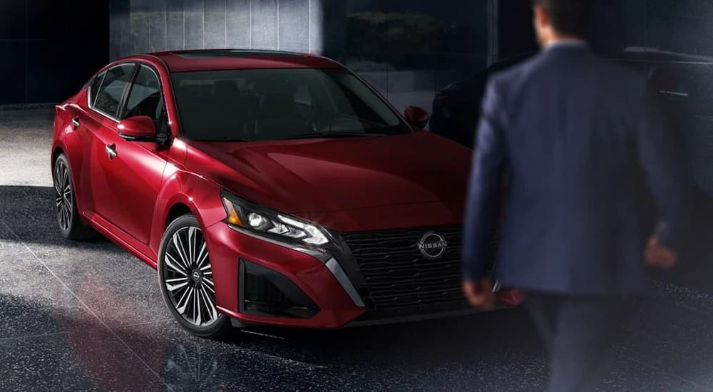 A red 2025 Nissan Altima SL is shown parked near a person walking.