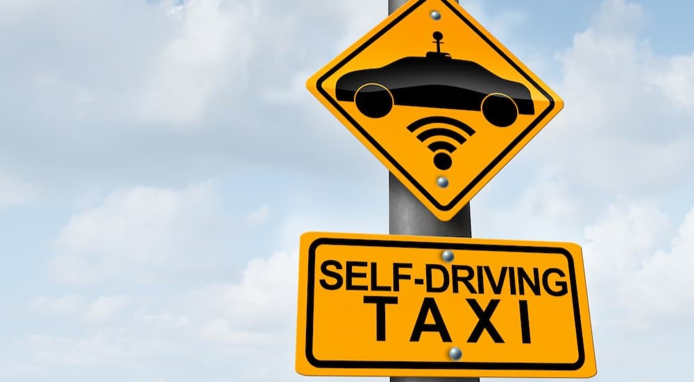 A self-driving taxi sign is shown.