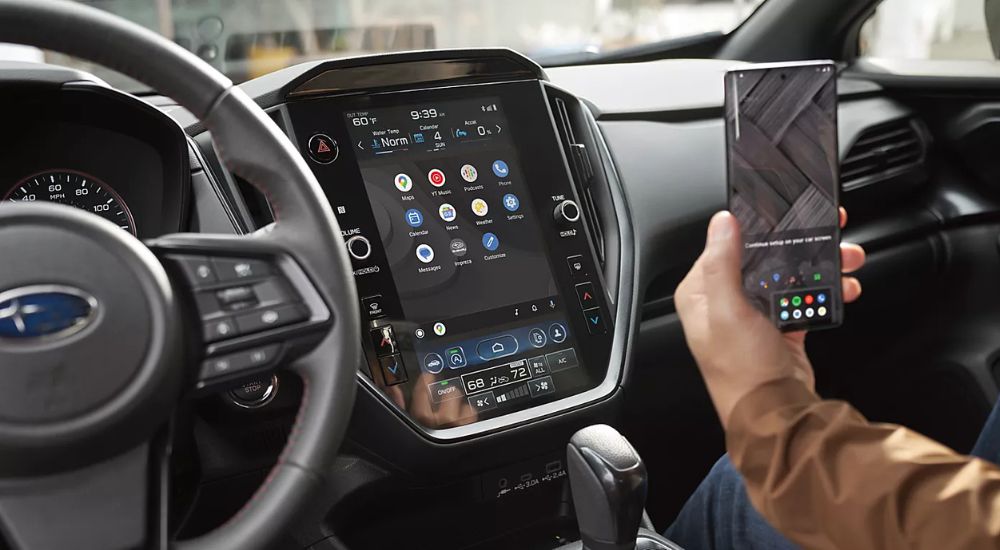 A passenger using the wireless Android Auto feature in a 2024 Subaru Impreza.