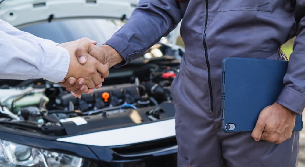 A technician and customer are shown shaking hands.