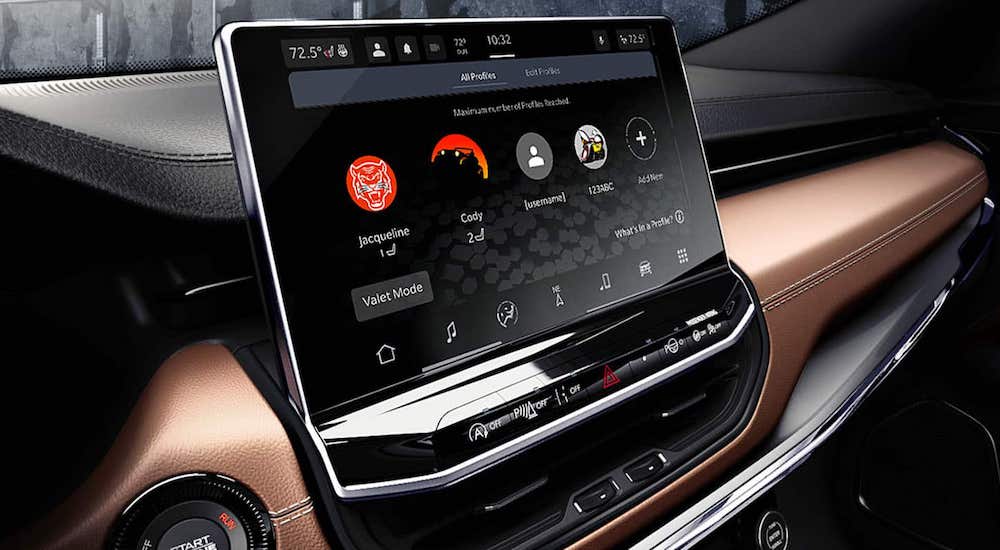 Close-up on the infotainment touchscreen in the interior of a 2025 Jeep Compass.